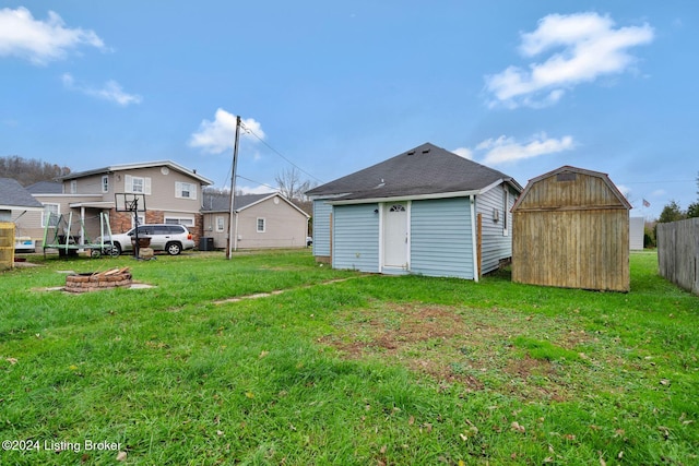 view of yard with a fire pit and a storage shed