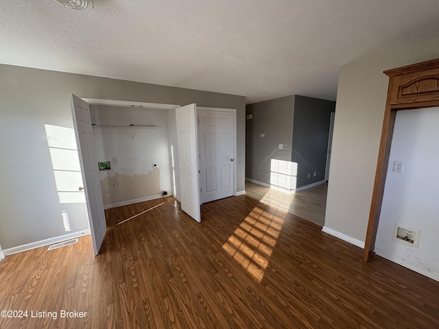 interior space with dark hardwood / wood-style floors and a textured ceiling