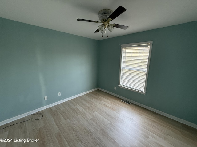 spare room featuring light hardwood / wood-style floors and ceiling fan