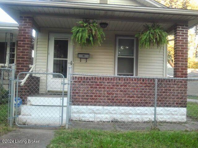 view of exterior entry with a porch