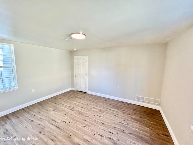 unfurnished room with light hardwood / wood-style floors