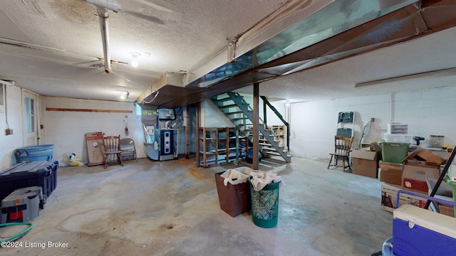 basement featuring a textured ceiling and heating unit