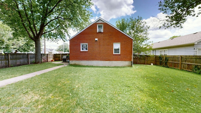 rear view of house with a yard