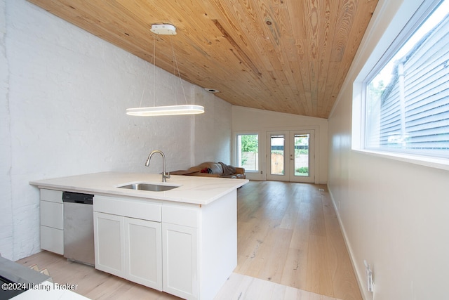 kitchen with french doors, sink, pendant lighting, lofted ceiling, and white cabinets