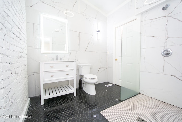 bathroom with toilet, a shower, tile walls, and vanity