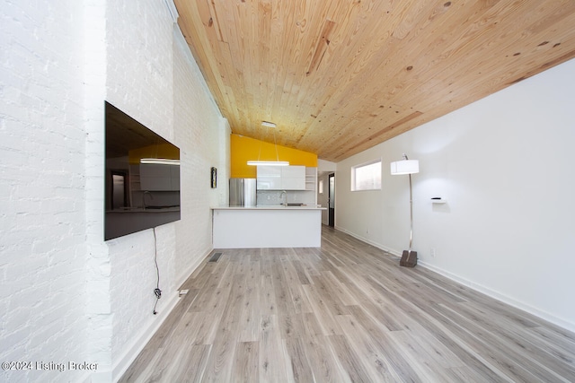 unfurnished living room with wooden ceiling, light wood-type flooring, sink, and vaulted ceiling