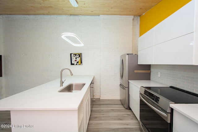 kitchen featuring white cabinetry, electric range, sink, backsplash, and light hardwood / wood-style floors