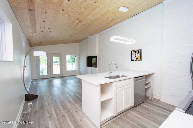 kitchen with dishwasher, white cabinets, sink, vaulted ceiling, and light hardwood / wood-style floors