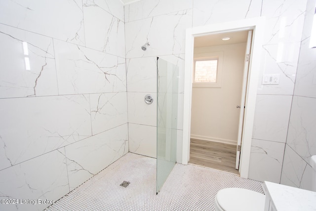 bathroom with toilet and tiled shower