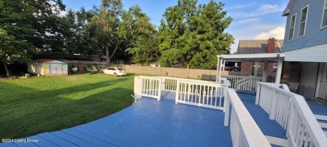 view of pool featuring a shed, a deck, and a yard