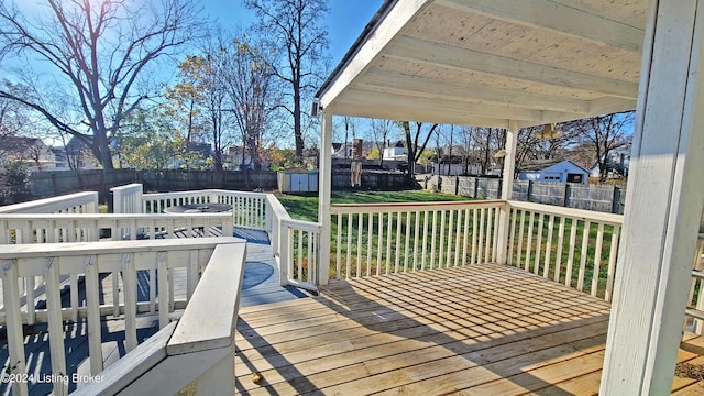 wooden deck featuring a yard and a shed