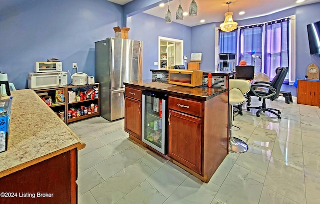 kitchen with stainless steel fridge, a center island, decorative light fixtures, and beverage cooler