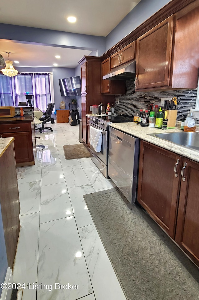 kitchen featuring backsplash, sink, and stainless steel appliances