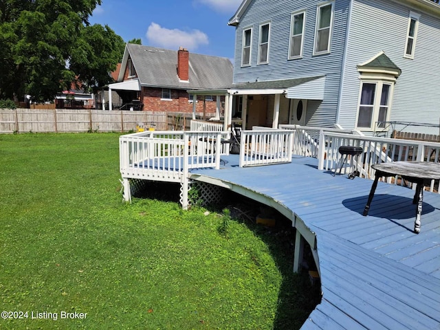 wooden terrace with a yard