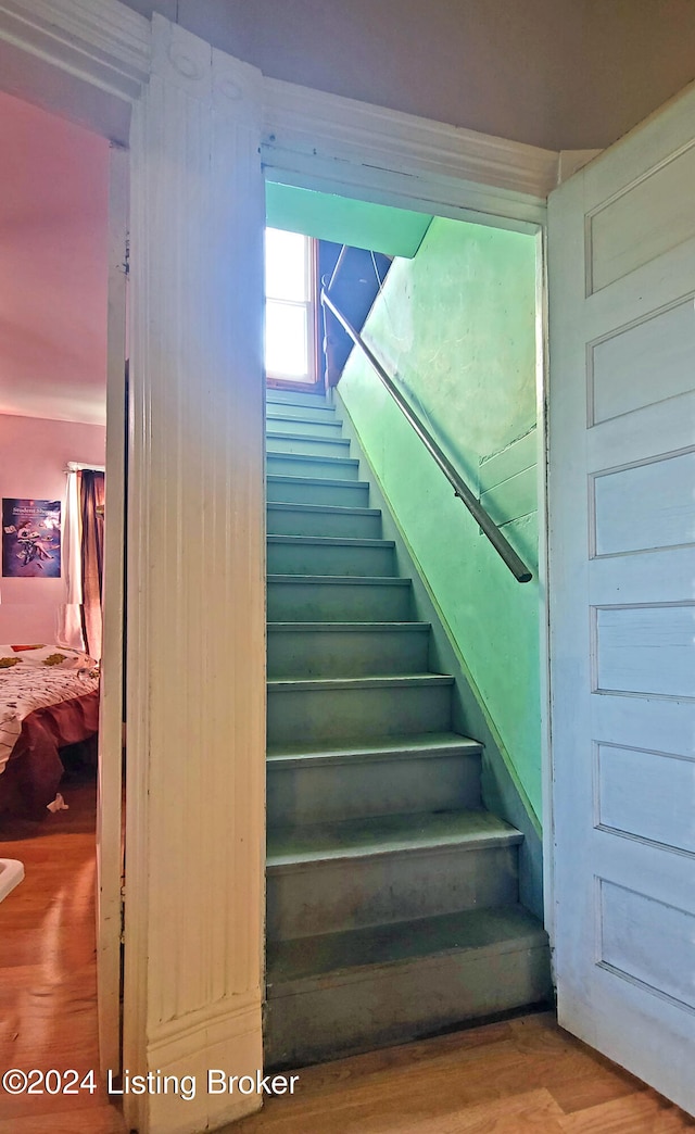 staircase with hardwood / wood-style flooring