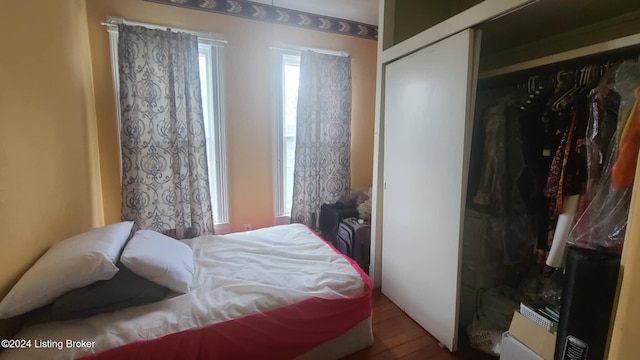 bedroom featuring wood-type flooring and a closet