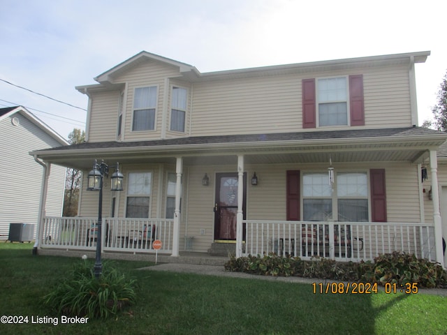 view of front of property with cooling unit and a front yard