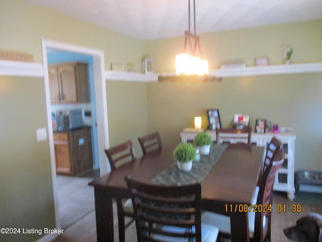 carpeted dining area featuring a notable chandelier