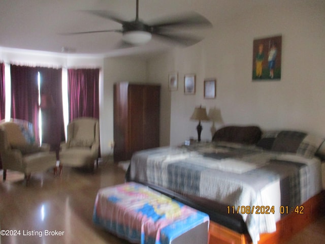 bedroom with ceiling fan and hardwood / wood-style flooring