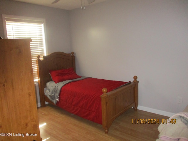 bedroom with ceiling fan and light hardwood / wood-style floors