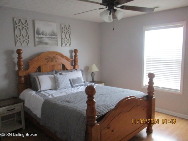 bedroom featuring hardwood / wood-style floors and ceiling fan