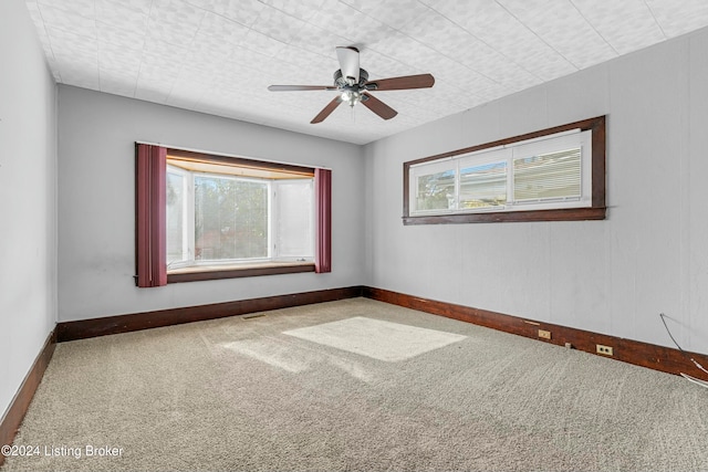 empty room with ceiling fan and carpet floors