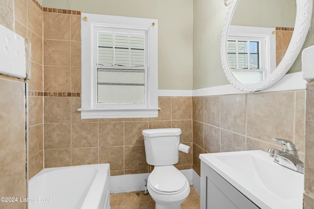 bathroom featuring vanity, tile patterned flooring, toilet, tile walls, and a tub