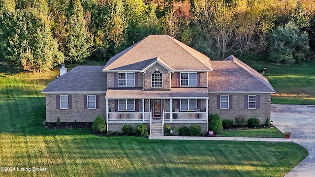 view of front of house with covered porch and a front yard