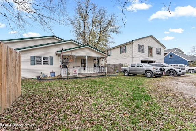 view of front of property with covered porch and a front yard