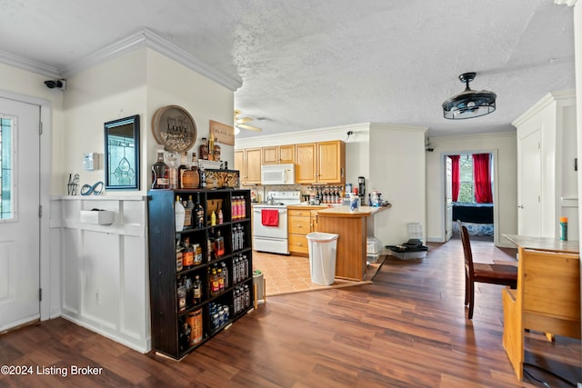 kitchen featuring dark hardwood / wood-style flooring, white appliances, and ornamental molding