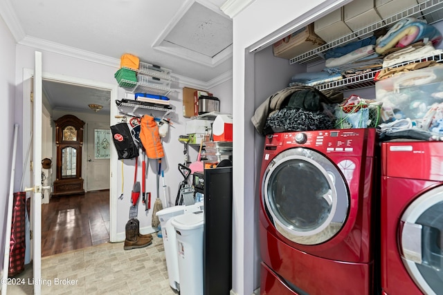 washroom featuring crown molding, washer and dryer, and light hardwood / wood-style floors