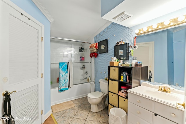 full bathroom with vanity, shower / bath combination with glass door, crown molding, tile patterned flooring, and toilet