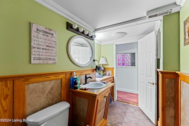 bathroom with vanity, toilet, and crown molding