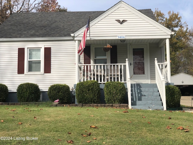 bungalow-style house featuring a front lawn and covered porch