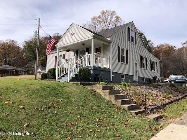 view of front of house with covered porch and a front yard