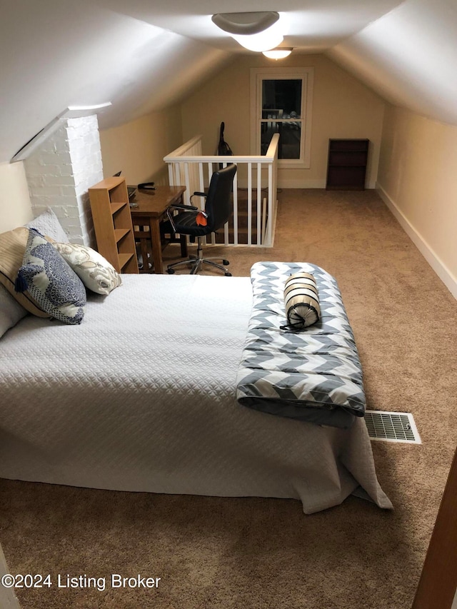 carpeted bedroom with lofted ceiling