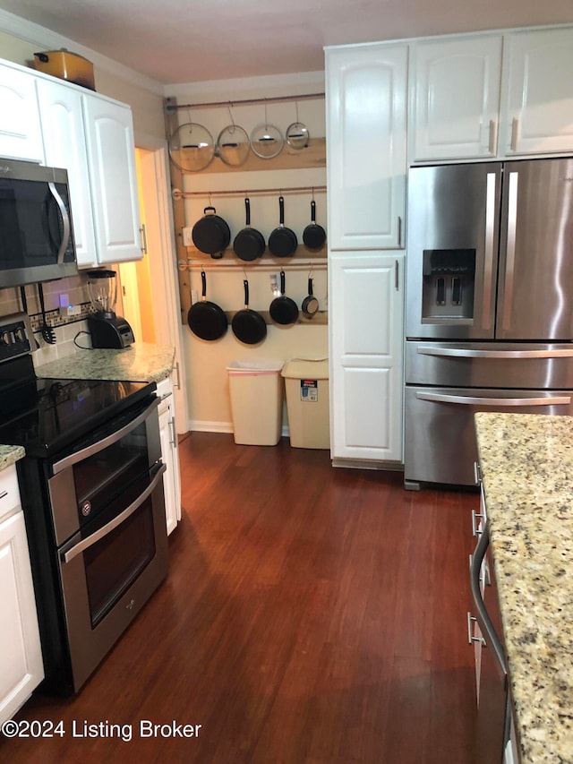 kitchen with white cabinets, dark hardwood / wood-style floors, light stone counters, and stainless steel appliances