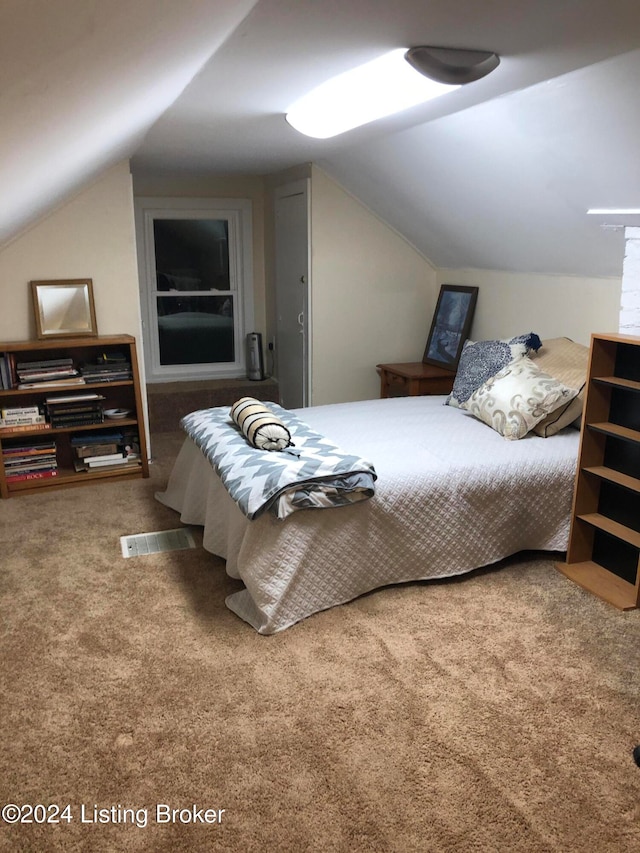 bedroom with carpet and lofted ceiling