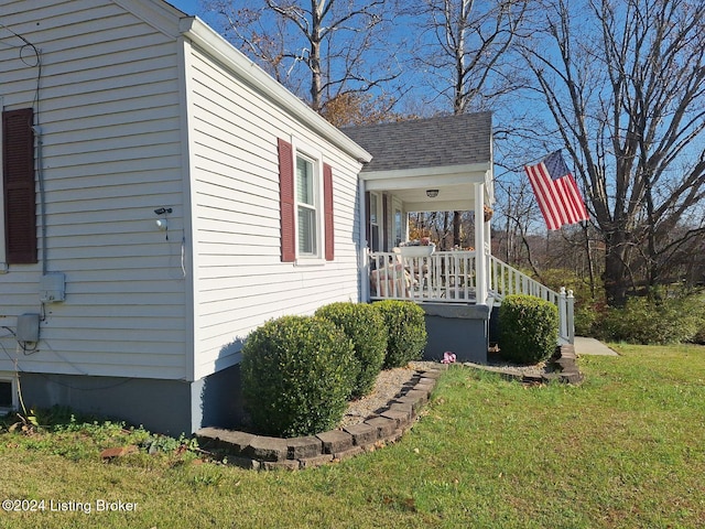 view of property exterior featuring a porch and a yard