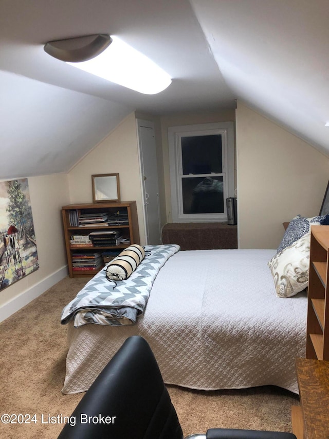 carpeted bedroom featuring lofted ceiling