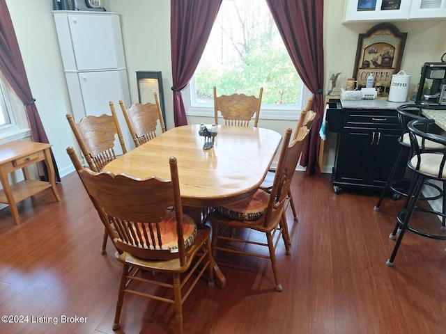 dining area with dark hardwood / wood-style flooring