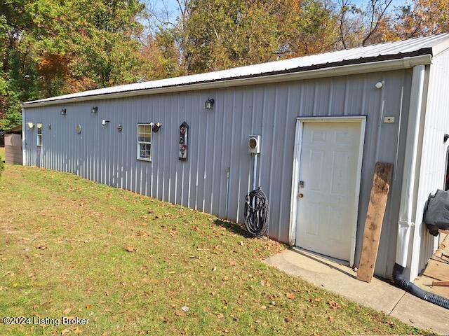 view of outbuilding with a yard