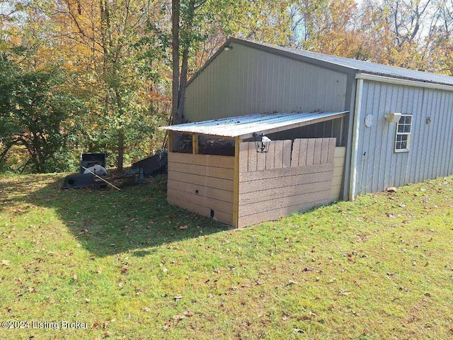 view of outbuilding featuring a lawn