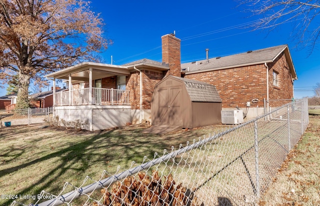 view of home's exterior with central AC unit, a storage shed, and a lawn