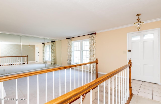 corridor featuring light tile patterned floors and crown molding