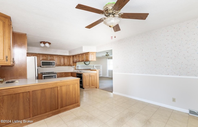 kitchen featuring wine cooler, ceiling fan, kitchen peninsula, and appliances with stainless steel finishes