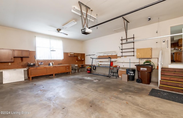 garage with a workshop area, ceiling fan, and a garage door opener