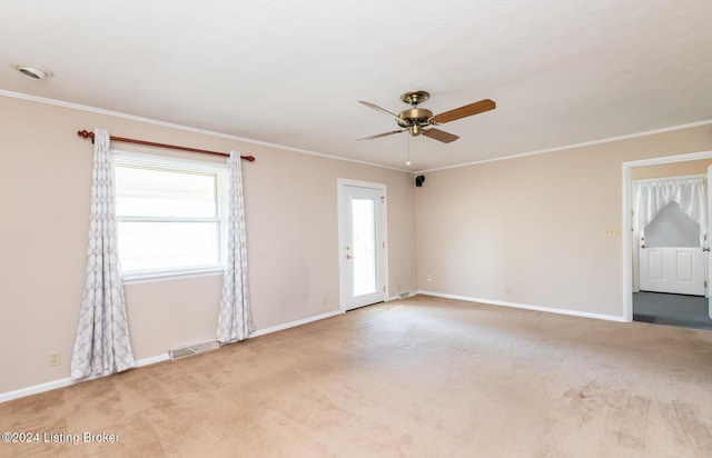 carpeted empty room with crown molding and ceiling fan