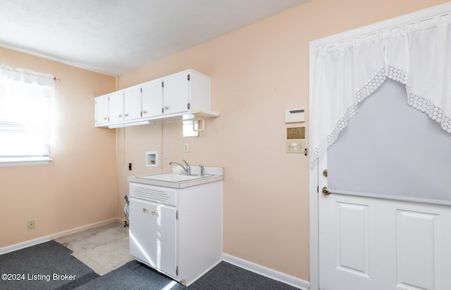 laundry room with washer hookup, carpet floors, and sink