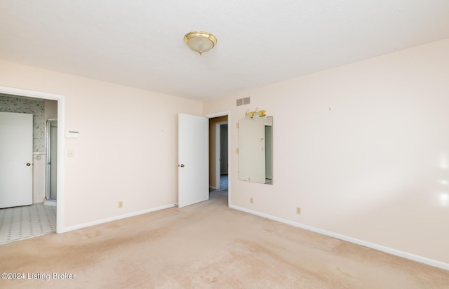 empty room with light colored carpet